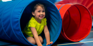 toddler playing in tunnel