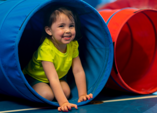 toddler playing in tunnel