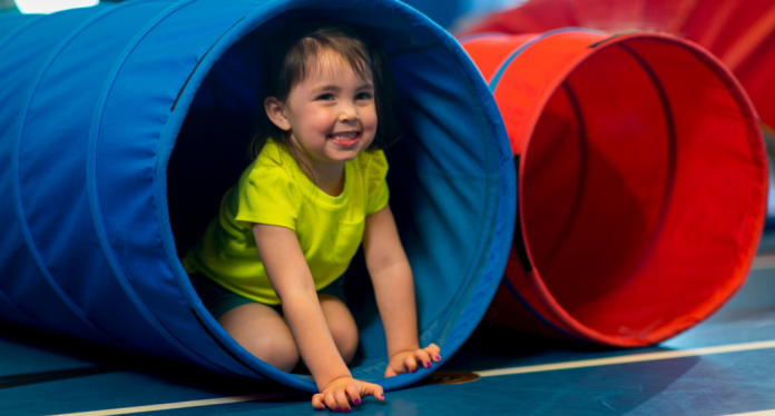 toddler playing in tunnel