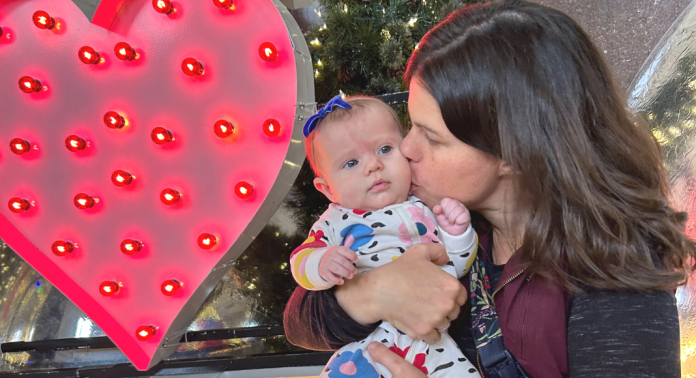 mom kissing baby