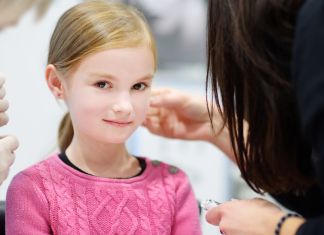 girl getting ears pierced