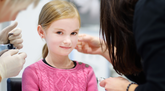 girl getting ears pierced