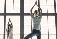 mom doing yoga pose with daughter