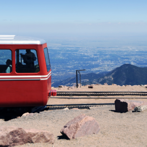 Pikes Peak Cog Railway at the summit with views of Colorado Springs in the background