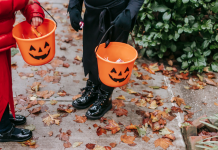 kids trick or treating carrying pumpkin buckets