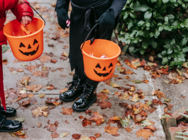 kids trick or treating carrying pumpkin buckets