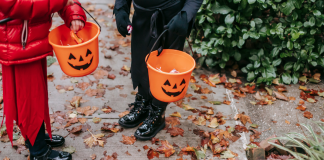 kids trick or treating carrying pumpkin buckets