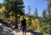 girl looking at fall leaves in Colorado