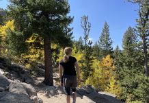 girl looking at fall leaves in Colorado