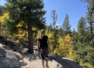 girl looking at fall leaves in Colorado