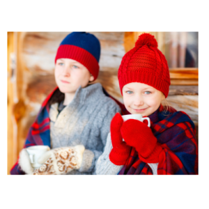 Two children sipping hot chocolate in winter gear