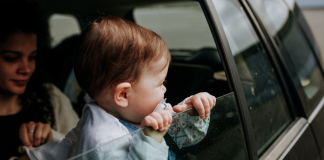 toddler looking out car window