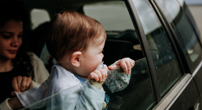 toddler looking out car window