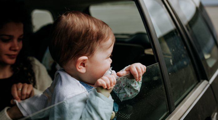 toddler looking out car window