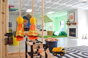 Tiny town featuring construction site and pet vet in the bright, open space at Happy Day indoor play space. 