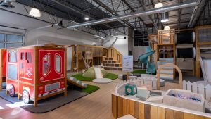 Multiple indoor play structures in open-concept design at Kickin' It Kids indoor playground. 